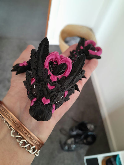 Emo Baby Heart Dragon held in a hand